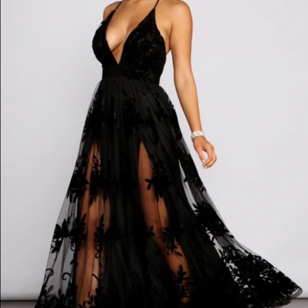 Black evening dress with velvet floral appliqués.